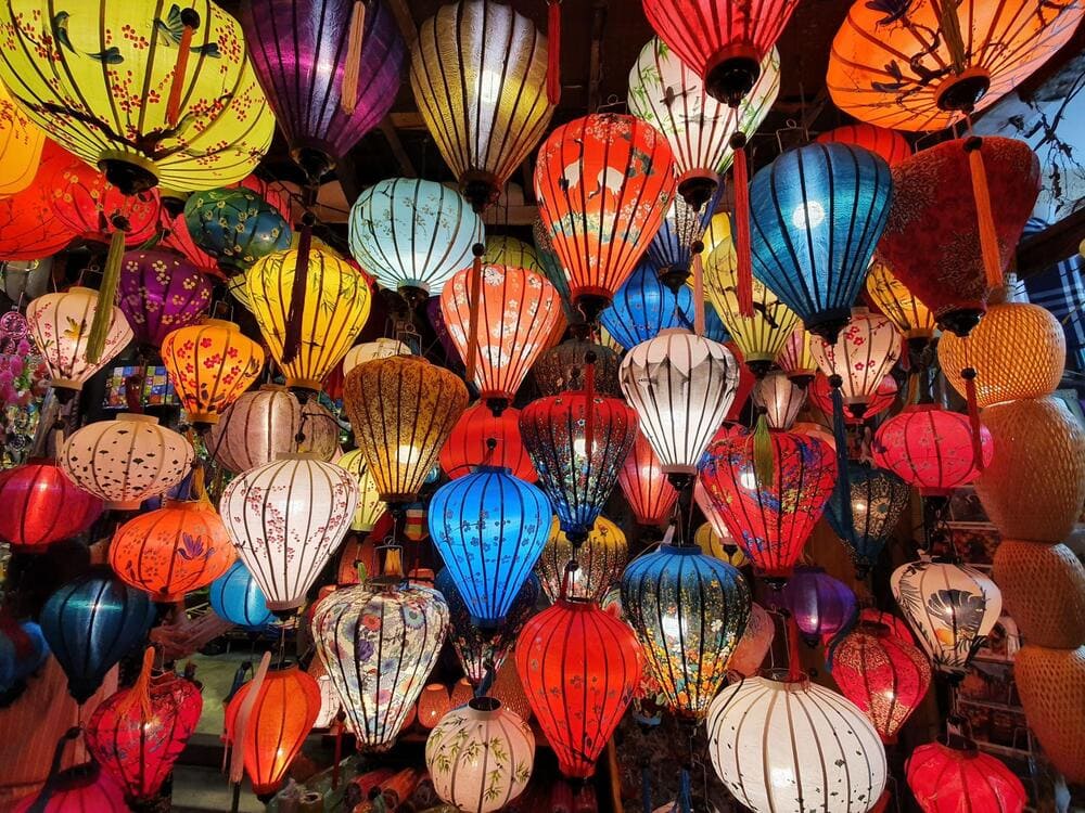 The lantern-lit streets of Hoi An Night Market create a magical, colorful atmosphere where glowing lanterns illuminate vibrant stalls
